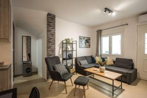 a living room with a couch and a table at Sofman city center apartment I in Heraklio