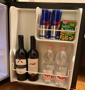 a refrigerator filled with bottles of wine and water at Villa Marogna in Alghero