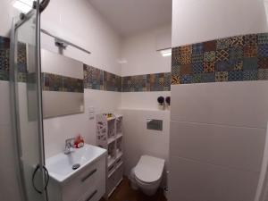 a bathroom with a toilet and a sink at Apartament Zachód in Warsaw