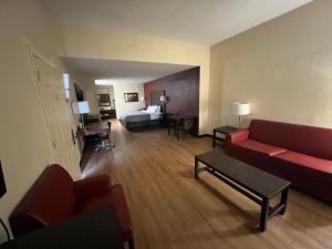 a living room with a couch and a bed in a room at Quality Inn & Suites I-10 near Fiesta Texas in San Antonio