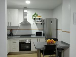 a kitchen with a table with a bowl of fruit on it at Apartamento ANY in Benaoján