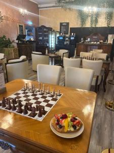 a chess board on a table with a plate of food at Mali Schachmuseum in Klagenfurt