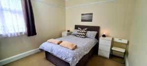a bedroom with a bed with two pillows on it at Victoria Mansions in Eastbourne