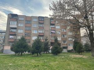a large apartment building with trees in front of it at OPTIMUM 2 - One bedroom apartment in Zenica