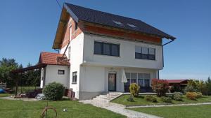 a white house with a black roof at Apartment Nana in Gradići