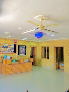 a ceiling fan in a living room with yellow walls at Thakurji Palace in Jaisalmer +19 photos