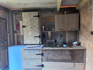 a kitchen with a blue refrigerator and a sink at Cabane 2 in Olivese