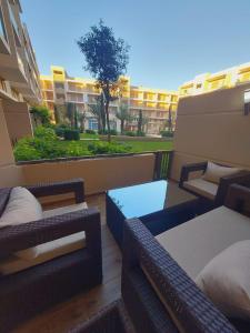 a balcony with wicker chairs and a table and a building at شارع محمد السادس ب مراكش in Marrakesh