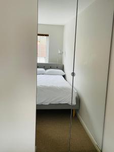 a bedroom with a bed and a mirror at Mezzo House- Entire property in Coventry