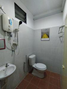a bathroom with a toilet and a sink at Dahliya Roomstay Langkawi in Pantai Cenang