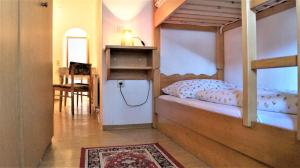a bedroom with two bunk beds and a dining room at Hochfilz´ner Hof in Hochfilzen