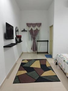 a room with a colorful rug on the floor at Dahliya Roomstay Langkawi in Pantai Cenang