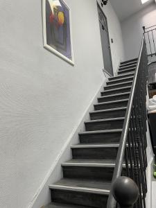 a stairway with a painting on the wall at AppartsHotels'De Ville in Bourg-lès-Valence