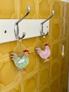 a pair of key hooks hanging on a wall at Charmant Studio en bord de Mer in Nice