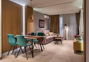 a living room with a couch and a table and chairs at City Park Inn Apartment Verona in Plovdiv