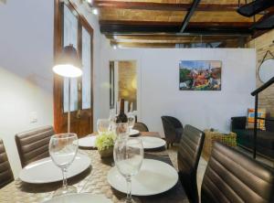 a dining room with a table with wine glasses at New Listing DUPLEX NEAR THE BEACH Barceloneta in Barcelona