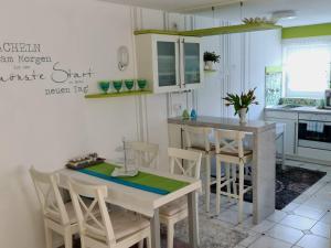 a kitchen with a table and chairs in a kitchen at Ferienwohnung Kessler in Rust