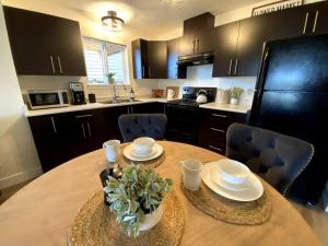 a kitchen with a wooden table with chairs and a dining room at Cozy Lakeview Suite in Victoria