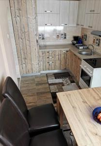 a kitchen with a table and a chair in it at Katarina Central House Predeal in Predeal