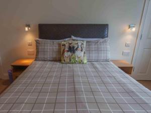 a bed with two dogs sitting on top of it at Shaftoe's Bed and Breakfast in Haydon Bridge