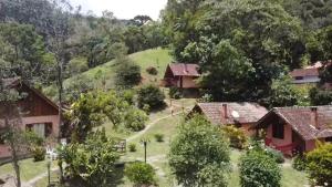 - une vue aérienne sur un village avec des maisons et des arbres dans l'établissement Pousada Caminho do Escorrega, à Visconde de Mauá