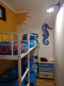 a bedroom with two bunk beds and a desk at Ocean View Dive House in Sesimbra