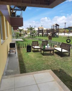 a park with benches and a playground in the background at Apto PDI na praia em Baixio in Baixio