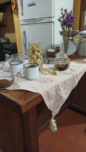 une table avec des bols et des tasses en haut dans l'établissement Miraflores Casa de Campo, à San Salvador de Jujuy