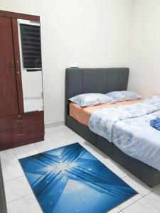 a bedroom with a bed and a blue rug at DAN'S Homestay Business Suite Home in Kota Tinggi