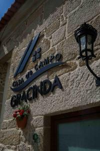 a sign for a restaurant on the side of a building at Casa de Campo Gracinda in Tourém