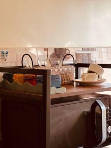 a kitchen with a counter top with plates and dishes at Wind and Wave Villa No 2, 2BHK Near Pondy Auroville Pondicherry in Marakkānam