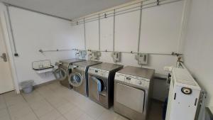a laundry room with two washing machines and a washer and dryer at Ferienwohnung Hafenblick in Wiek auf Rügen 