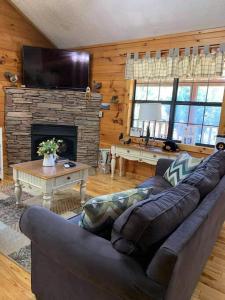 a living room with a couch and a fireplace at Little Cabin All To Yourself in Sevierville