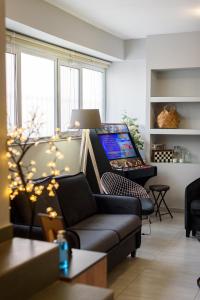 a living room with a couch and a laptop computer at Patras' Hitech Apartment in Patra