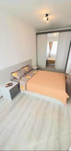 a small bedroom with a bed and a mirror at 1 apartament lux cu parcare privată gratuită in Iaşi