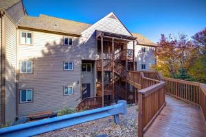 a large house with a deck and a house at Pour Some Sugar On Me - Long-Range Mountain Views in Sugar Mountain