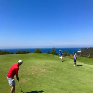 a group of people playing golf on a golf course at HAMEAU DES AMANDIERS - vue mer, golf et vignes in Saint-Cyr-sur-Mer