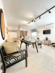 a living room with a table and chairs in it at LA Casa Di Lusso N7 -Adults Only in Kolymbia