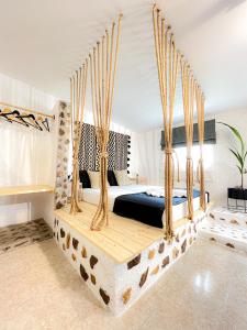 a bedroom with a bed with a wooden swing at LA Casa Di Lusso N7 -Adults Only in Kolymbia
