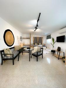a living room with a table and chairs at LA Casa Di Lusso N7 -Adults Only in Kolymbia