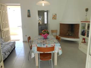 a dining room with a table and a fireplace at Casa Raffaele in Leuca