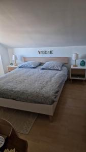 a bedroom with a bed with two pillows on it at Entre Alpes et Léman in Publier