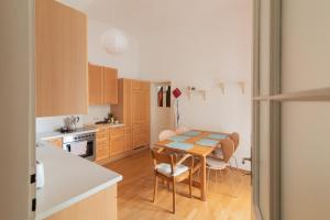 a kitchen with a table and chairs in a room at hostel mapijaru in Klagenfurt