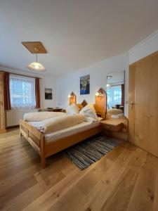 a large bedroom with a large bed and a bathroom at Haus Alpenglühn in Schladming