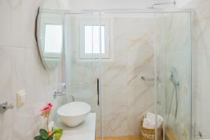 a bathroom with a shower with a toilet and a sink at Philoxenia Ganossis in Ermioni +26 photos