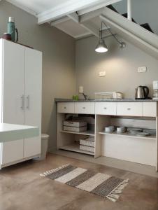 a kitchen with white cabinets and a sink at Premium Loft of the Fountain Small Plaza w/Netflix in Buenos Aires