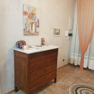 a wooden dresser with a counter top in a room at Marco's Apartment Colosseum in Rome