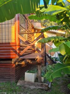 a wooden bench sitting in front of a building at Cabaña Alma 2 in Villa Carlos Paz