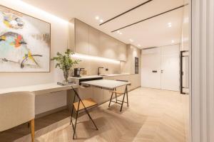 a kitchen with a counter and a table in a room at MyHouseSpain - Luminoso piso en Chamberí in Madrid