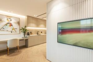 a living room with a large television on a wall at MyHouseSpain - Luminoso piso en Chamberí in Madrid